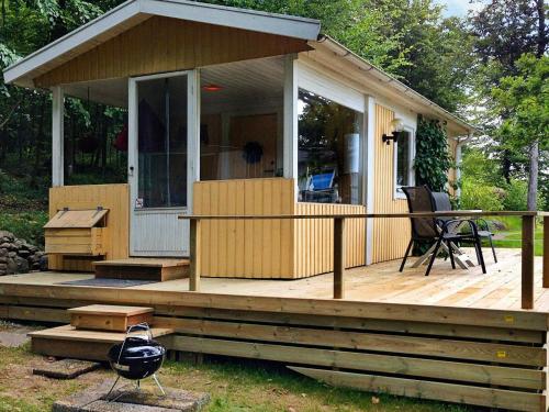 a house with a deck with a table and a chair at 2 person holiday home in TYRINGE-By Traum in Tyringe