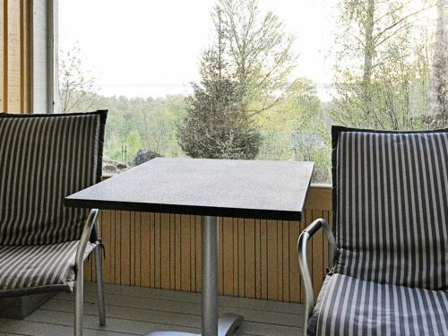a table and two chairs on a porch with a window at 2 person holiday home in TYRINGE-By Traum in Tyringe