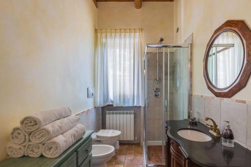 a bathroom with a sink and a shower and a toilet at Villa Eden in Campofilone