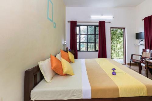 A bed or beds in a room at Grace Inn Munnar Homestay