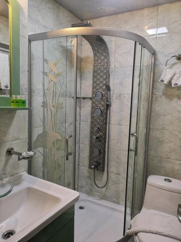 a bathroom with a shower and a sink at Complex Koko Hills in Sapareva Banya