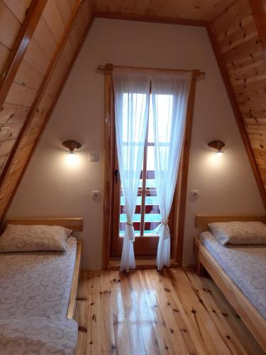 a bedroom with two beds and a window at Mountain House Tadić 1 in Bajina Bašta