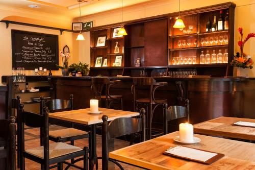 a restaurant with tables and chairs and a bar at Arch Guesthouse in Clifden