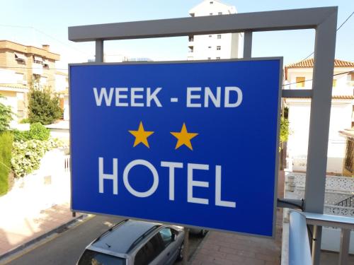 
a blue and white sign on a street at Hotel Fin De Semana in Gandía
