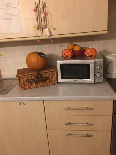 a kitchen counter with a microwave and pumpkins on it at Drop Anchor in Dartmouth