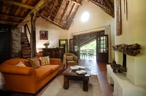 a living room with a couch and a table at Rivertrees Country Inn in Usa River