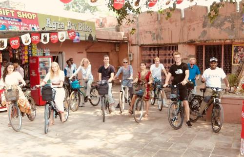 a group of people on bikes in front of a store at Zigzag Homestay in Agra