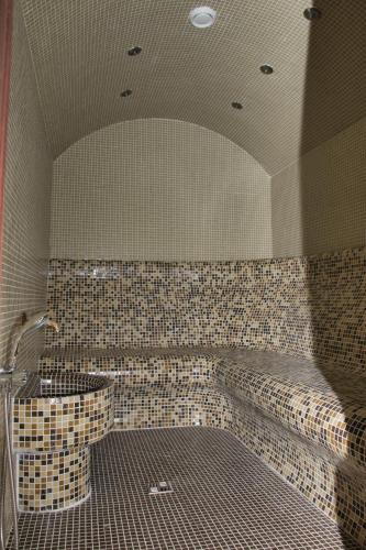 a tiled bathroom with a tub and a sink at Balneo and SPA Complex MINERAL YAGODA in Yagoda