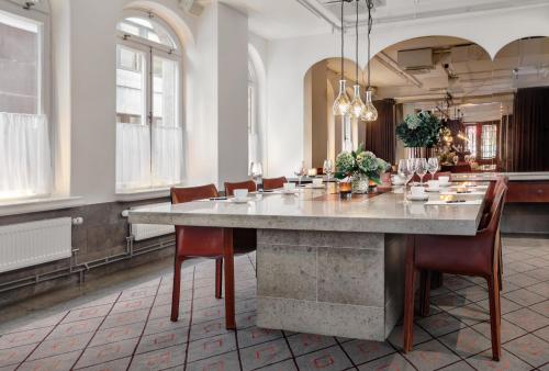 a large dining room with a large table and chairs at Miss Clara by Nobis, Stockholm, a Member of Design Hotels in Stockholm