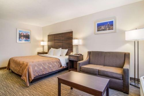 a hotel room with a bed and a chair at Quality Inn Suwanee I-85 in Suwanee