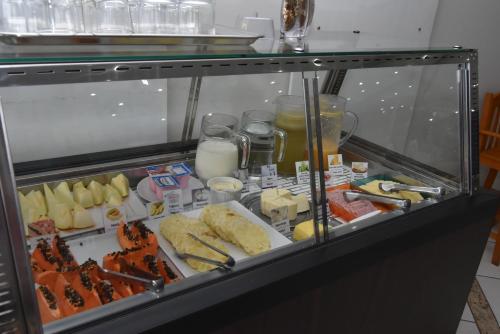a refrigerator filled with lots of different types of food at Hotel Vilhar in Ivaiporã