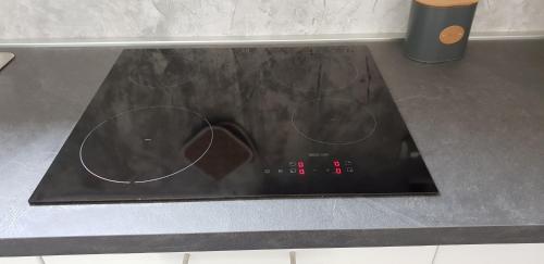 a stove top with four dials on a counter at casa ottaviano in Bologna