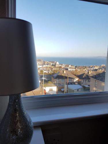 a lamp sitting next to a window with a view at The Trelinda Guest House in Newquay