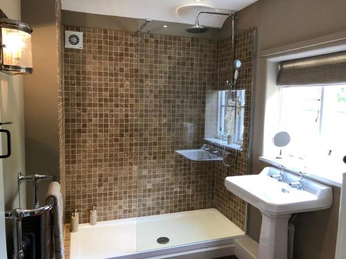 a bathroom with a tub and a sink and a shower at Little Doric in Shepton Mallet