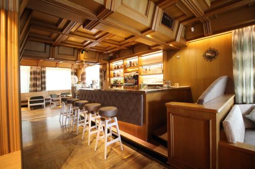 a bar with a row of stools in a restaurant at Astor Suites B&B in Selva di Val Gardena