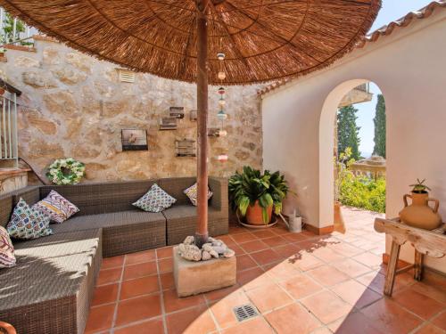 an outdoor living room with a couch and an umbrella at Holiday Home Petite Fleur by Interhome in Montgo