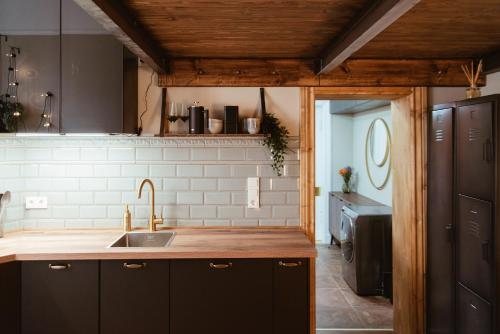 a kitchen with a sink and a counter top at LoftBrücke, Apartment am Platz der Luftbrücke in Berlin