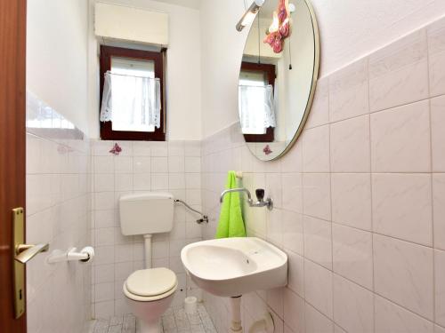 a bathroom with a toilet and a sink and a mirror at Apartment Lidija by Interhome in Vir