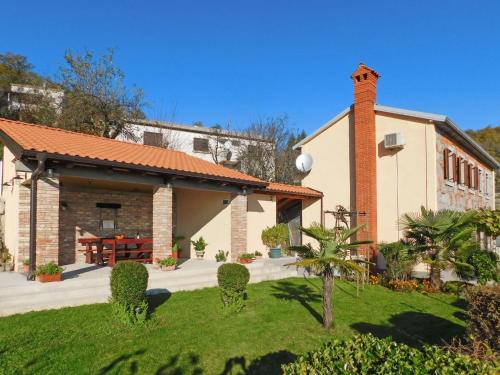 a building with a brick chimney and a courtyard at Holiday Home Lea by Interhome in Rukavac