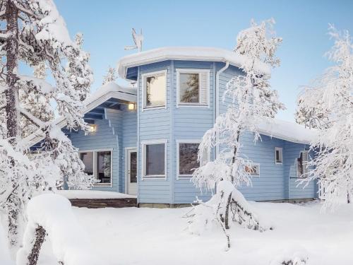 a blue house in the snow at Holiday Home Vuonelo by Interhome in Saariselka