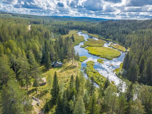 an aerial view of a river and forest at The Old Logging Camp in Yttermalung