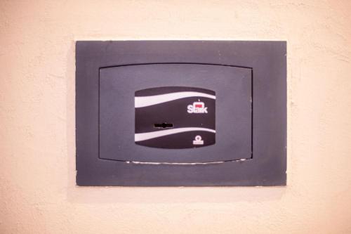 a blue lightswitch on a wall with a picture on it at Incanto Manarola in Manarola
