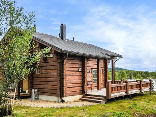 a log cabin with a porch and a deck at Holiday Home Aamunkoi by Interhome in Veskoniemi