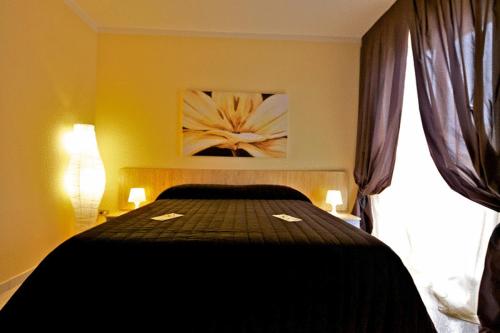 a bedroom with a bed in a room with a window at Valentino in Valenzano