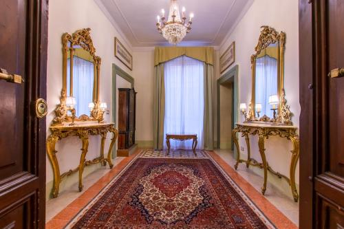 a hallway with two mirrors and a rug at Sant'Ivo Apartments in Rome