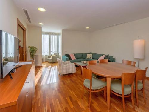 a living room with a wooden table and a couch at Apartment Plaza Catalunya-Rda-Universidad by Interhome in Barcelona