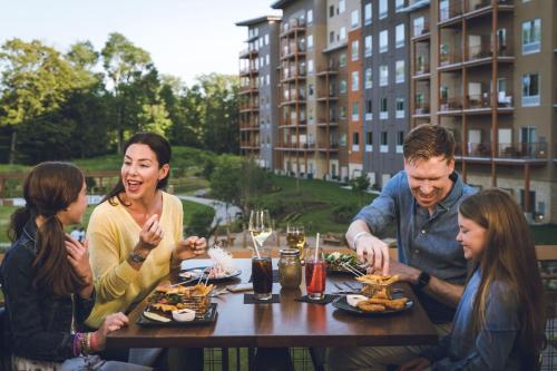 a group of people sitting around a table eating food at The Kartrite Resort and Indoor Waterpark in Monticello