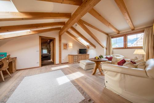 a large living room with wooden ceilings and beams at Romantik Hotel Oberwirt in Marlengo