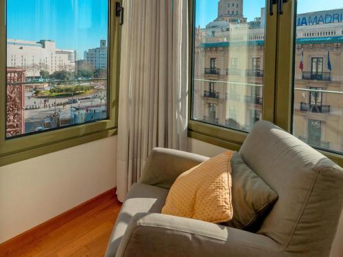 a living room with a couch and a large window at Apartment Plaza Catalunya-Rda-Universidad by Interhome in Barcelona
