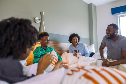 a group of people sitting on a bed at The Kartrite Resort and Indoor Waterpark in Monticello