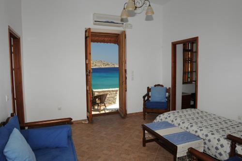 a bedroom with a bed and a view of the ocean at Villa Zeus in Symi