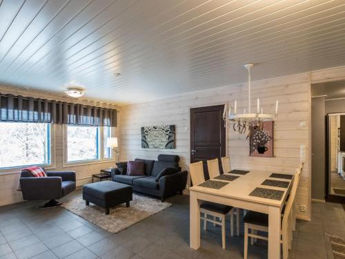 a living room with a table and a couch at Holiday Home Hil-lak-ka ii as 5 by Interhome in Äkäslompolo