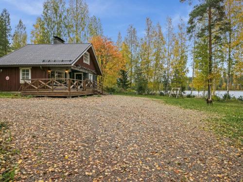 a barn with a dog standing in front of it at Holiday Home Talasniemi by Interhome in Hara