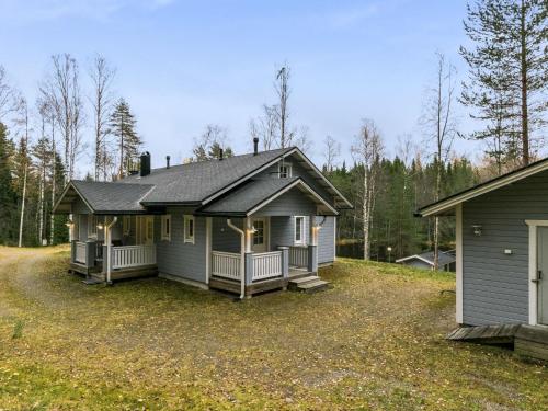 a small house with a porch on a yard at Holiday Home Rinteelä by Interhome in Heinävesi