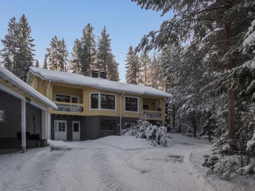 a yellow house with snow on the ground at Holiday Home Vaarapirtti - tähti by Interhome in Lahdenperä