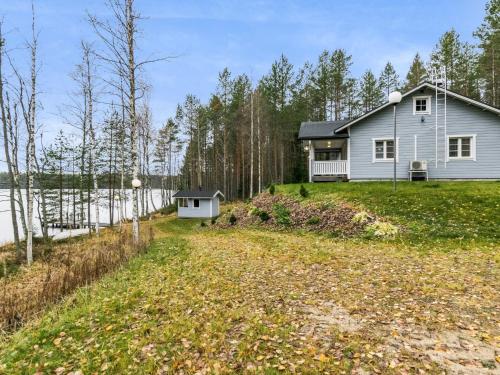 a house on a hill with a yard at Holiday Home Rinteelä by Interhome in Heinävesi