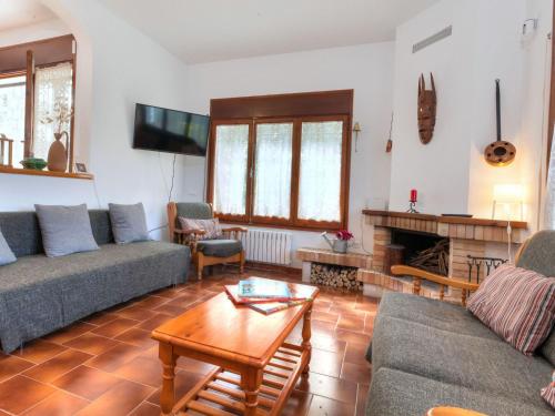 a living room with two couches and a fireplace at Holiday Home Paradis by Interhome in Mont Barbat