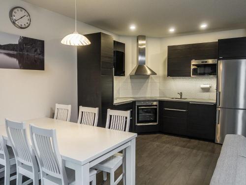 a kitchen with a white table and white chairs at Holiday Home Klz krysoliitti by Interhome in Vuokatti