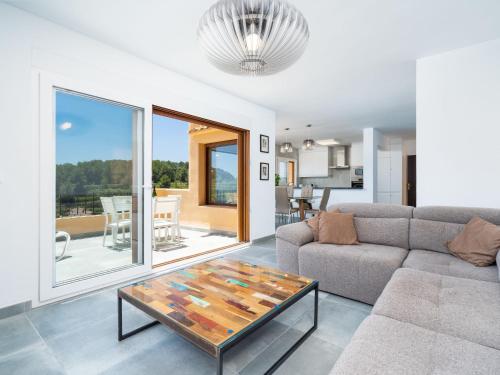 a living room with a couch and a table at Apartment Miramar by Interhome in Moraira