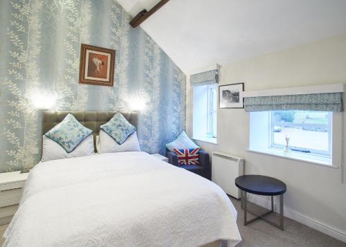 a bedroom with a large bed and a window at Host & Stay - Rosella Cottage in Pickering