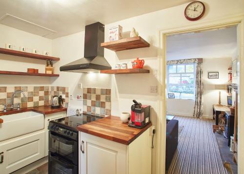 a kitchen with a stove and a counter top at Host & Stay - Rosella Cottage in Pickering
