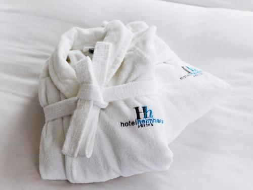 a white towel sitting on top of a bed at Boutique Hotel Helmhaus Zürich in Zurich