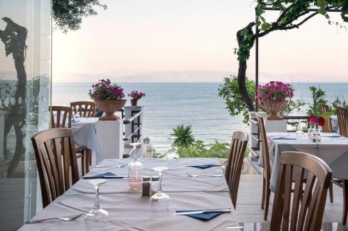a table with a view of the ocean at Hotel Kaiser Bridge in Benitses