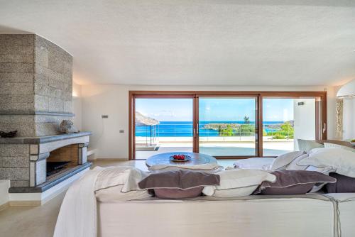 a living room with a bed and a fireplace at Elounda Lavender Villa in Elounda