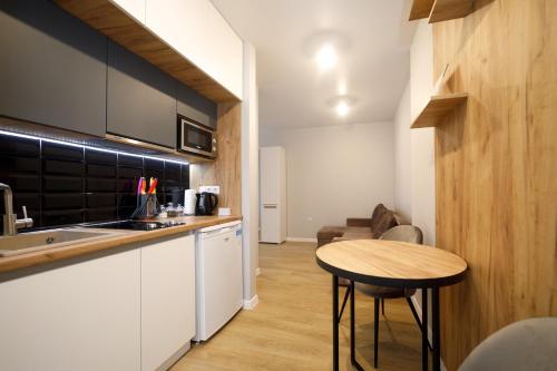 a small kitchen with a table and a counter at Pure Apartments in Lviv