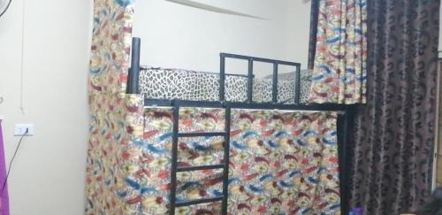 a bunk bed in a room with a curtain at Cliff Hostel in Amman